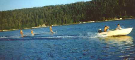 Three Waterskiers behind the Sande Ace